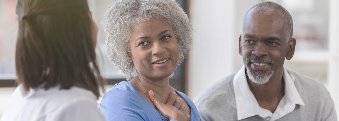 Health care provider talks with an older couple